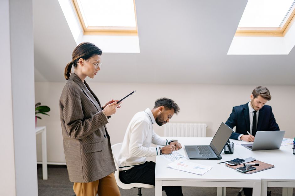 A diverse group of professionals working together in a bright, modern office space.